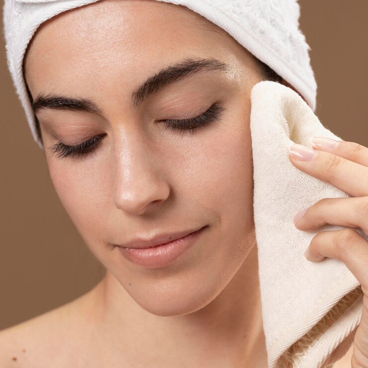 young-woman-touching-her-face-with-towel_23-2148895532